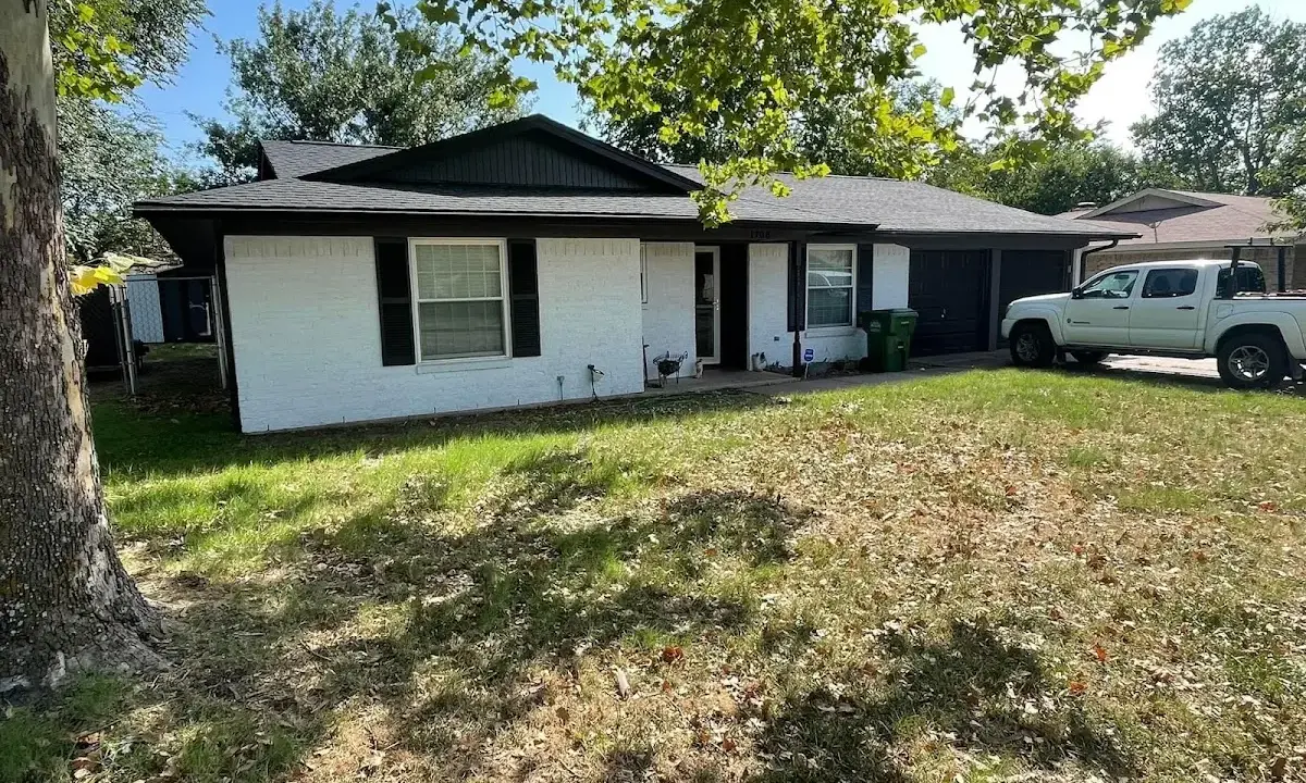 Professional roofing crew working on a residential roof in Highlands